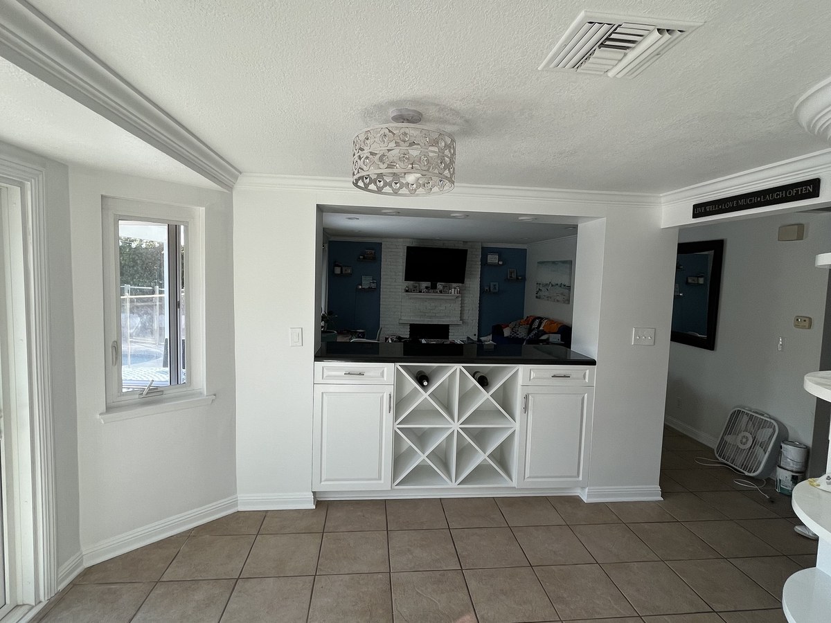 After: built-in wet bar cabinetry refinished in white