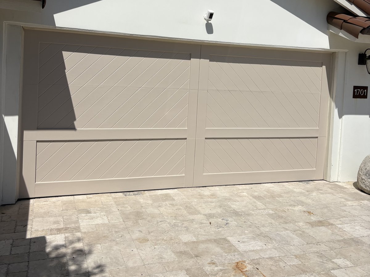 After: garage door refinished with a warm wood-grain stain