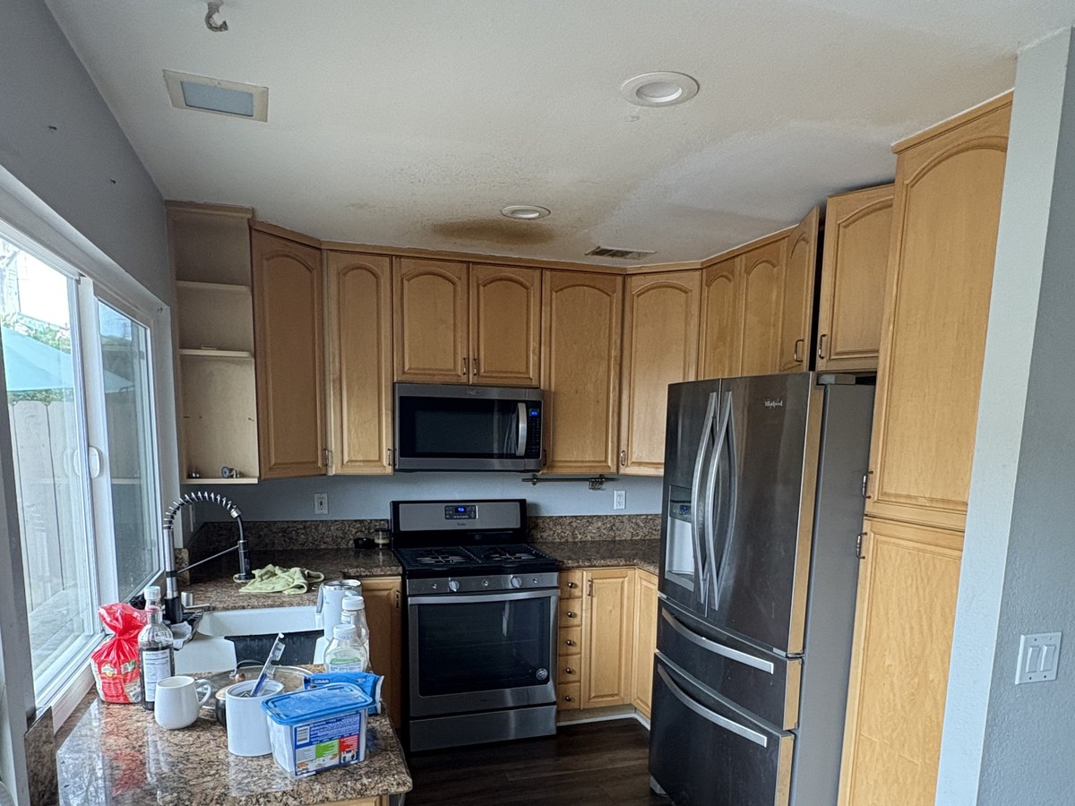 Before: original natural wood cabinets
