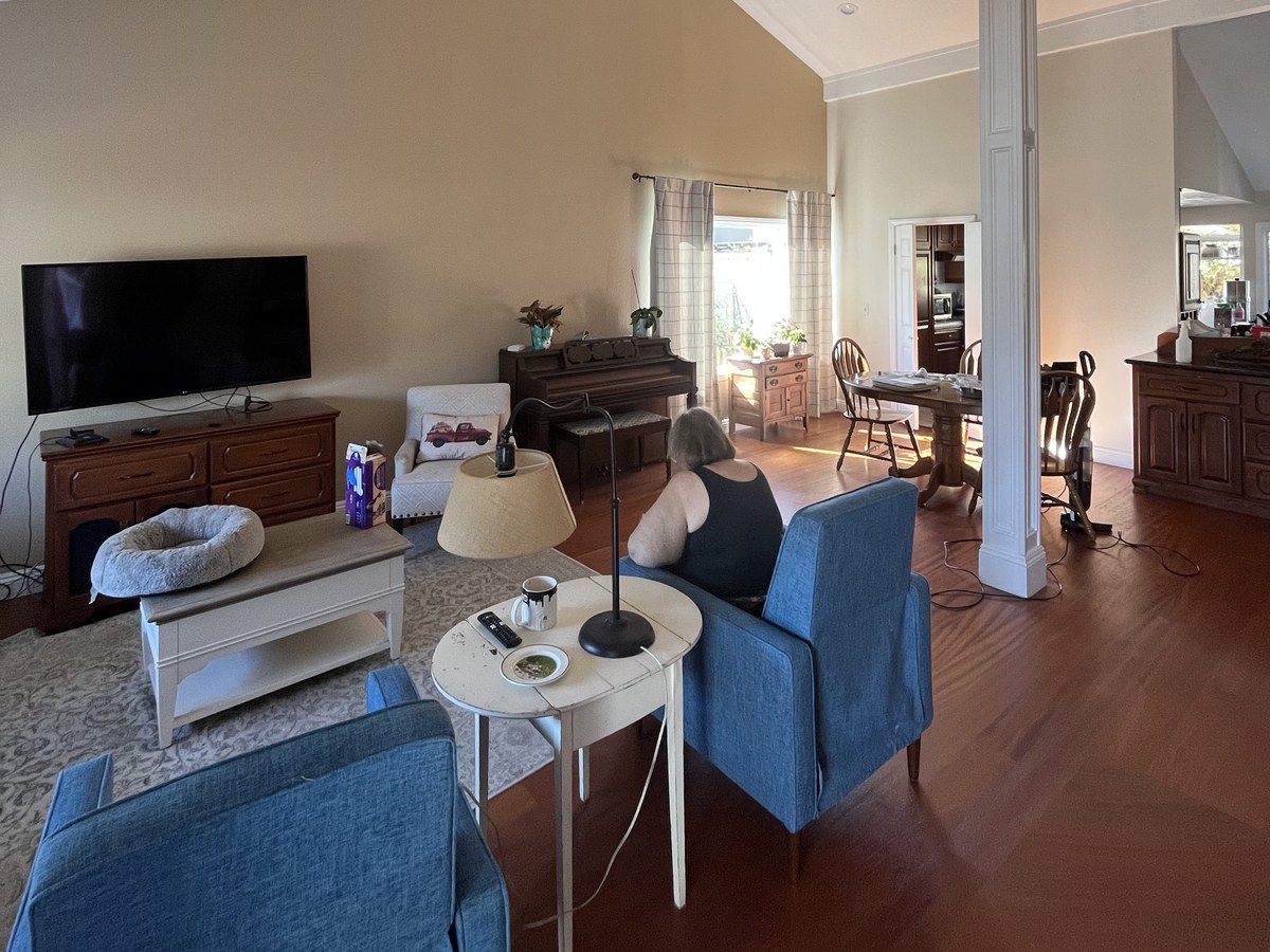 Living room mid-prep with furniture moved to the center of the room